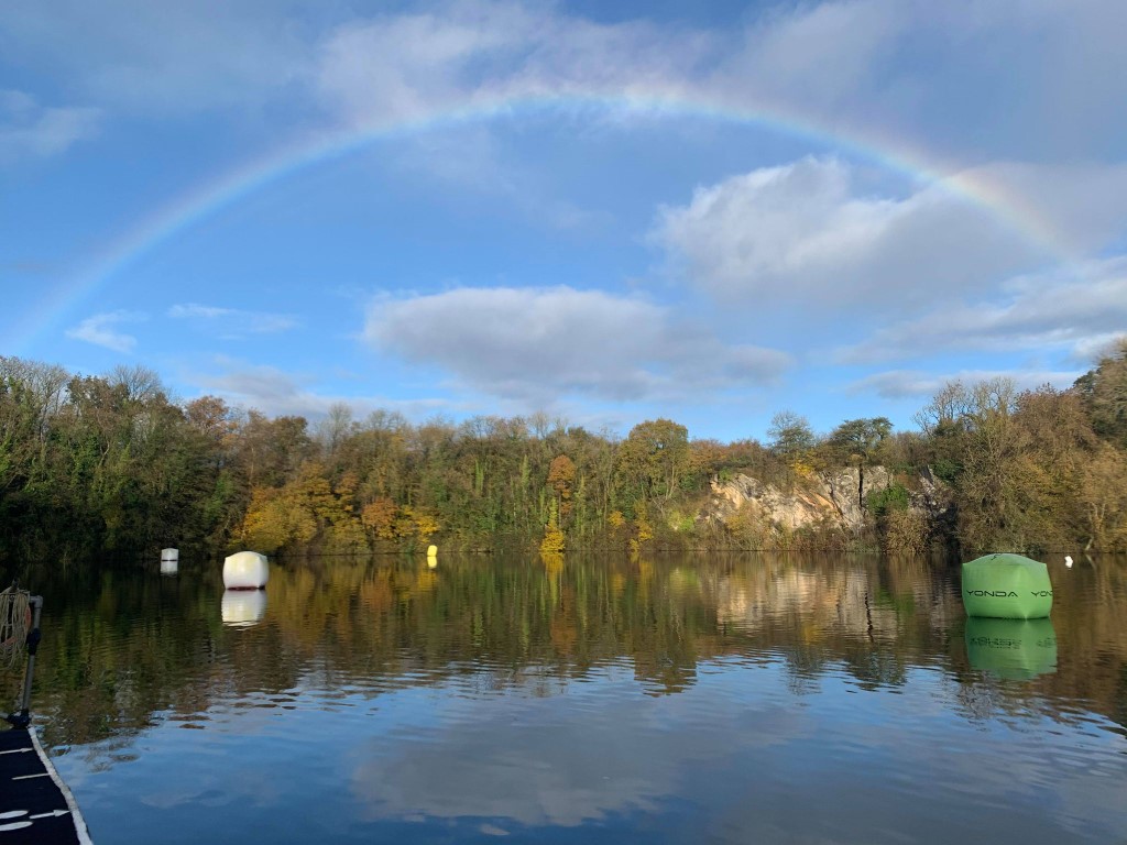 Photograph of a rainbow over the lake